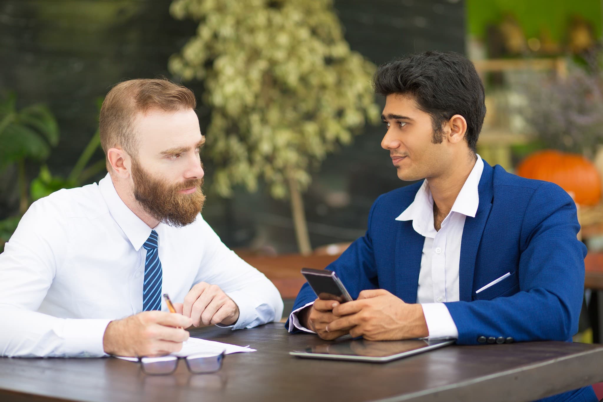 Two people talking through a reselling workflow.